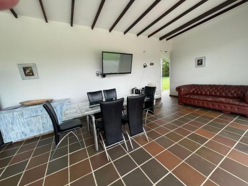 a living room with a couch and a table and chairs at Finca La Ranchera No. 2 in Tarso