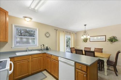 a kitchen with a counter and a table and a dining room at Perry's Manor in Jekyll Island