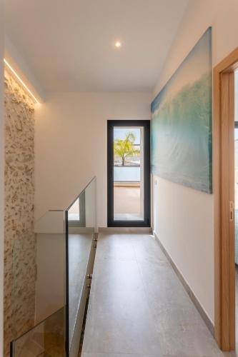 a hallway of a house with a glass staircase at Son Ramis in Llubí