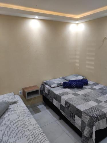 a bedroom with two beds and a table in it at Aconchego do Áureo in Pacoti