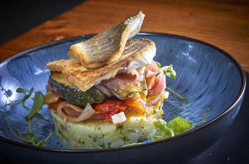 a sandwich with toast and vegetables on a blue plate at The Ingram Arms in Laughton