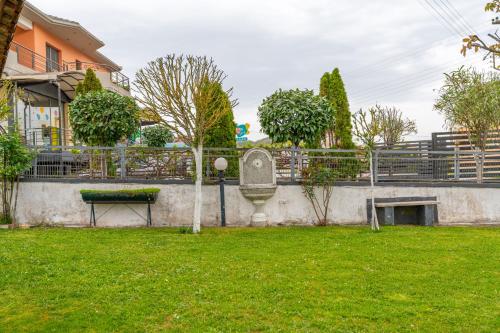 a park with a bench and a fence at Sofita Ioannina Eleousa in Eleoúsa