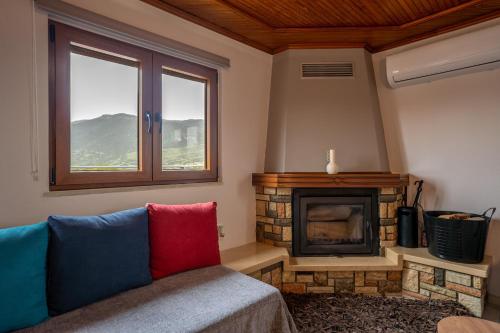 a living room with a couch and a fireplace at Sofita Ioannina Eleousa in Eleoúsa