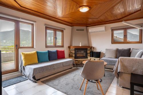 a living room with two couches and a fireplace at Sofita Ioannina Eleousa in Eleoúsa