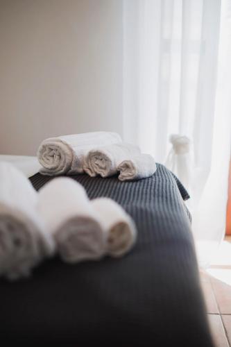 a pile of towels sitting on top of a bed at Don Ciccio Apartments&Suite in Conversano