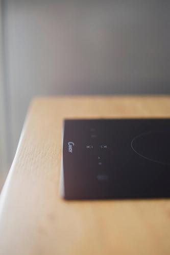a black object sitting on top of a wooden table at Don Ciccio Apartments&Suite in Conversano