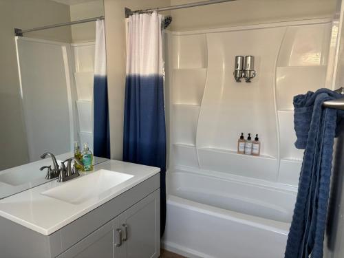 a bathroom with a sink and a tub and a shower at Jacuzzi 6 bedroom close to downtown Beautiful in National City