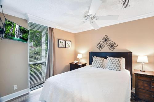 a bedroom with a bed and a large window at Villa 401 in Jekyll Island