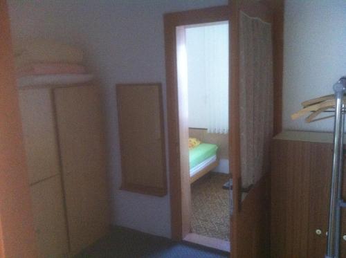 a small room with a bathroom with a mirror and a closet at Penzion u Skaláků in Dolní Dunajovice