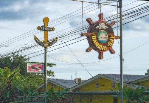 a sign for a seafood restaurant and a sign for at Banana Bay Marina in Golfito