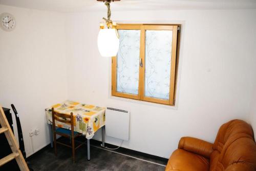 un salon avec une table et une fenêtre dans l'établissement Studio avec Mezzanine, à Saint-Maur-des-Fossés