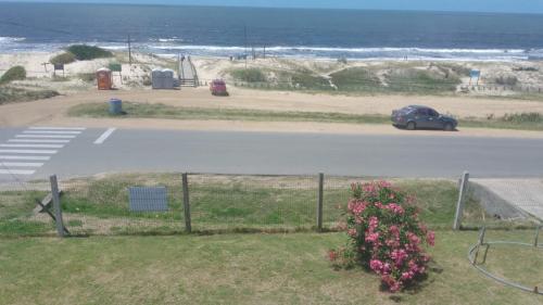 a car parked on a road next to the beach at Duplex Poseidon in Las Toscas