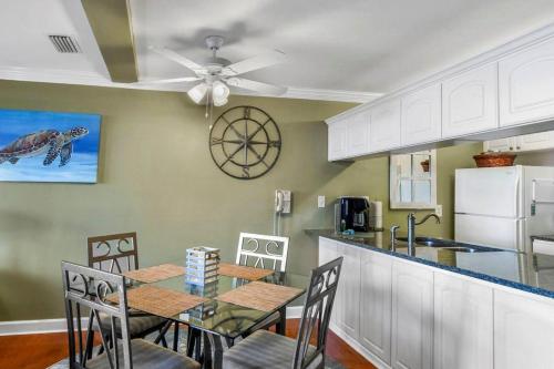 a kitchen with a dining table and a ceiling fan at Villa 377 Turtle Villa in Jekyll Island