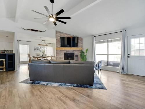a living room with a couch and a fireplace at Plano House close to Mckinney and Oak Point Park in Plano