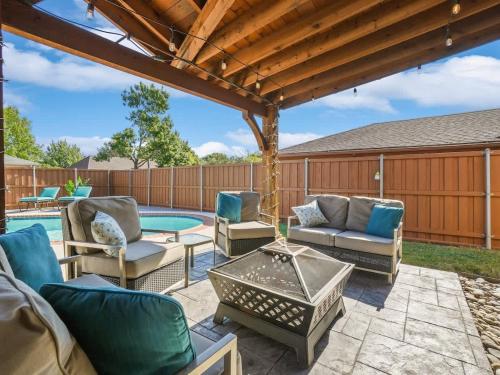 a patio with chairs and a table and a pool at Plano House close to Mckinney and Oak Point Park in Plano