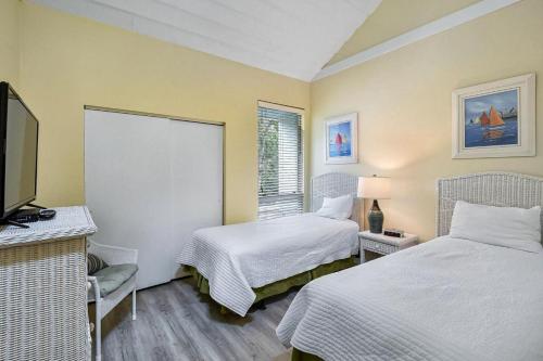 a hotel room with two beds and a television at Villa 435 in Jekyll Island