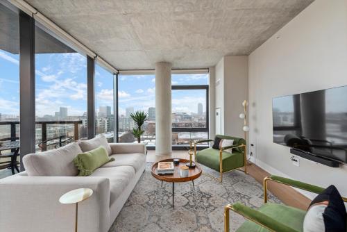 a living room with a couch and a table at Sage Modern Apartments Near Union Park in West Loop in Chicago