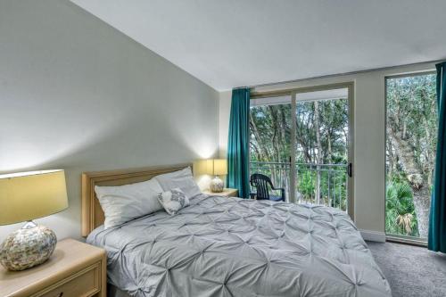 a bedroom with a bed and a large window at Villa 452 in Jekyll Island
