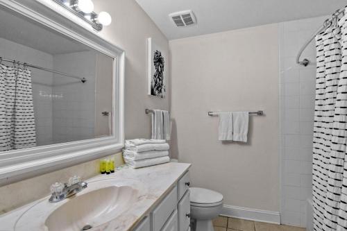 a white bathroom with a sink and a toilet at Villa 452 in Jekyll Island