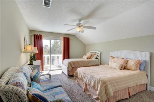 a living room with two beds and a couch at Spectacular Sunrise in Jekyll Island