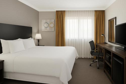 a hotel room with a large bed and a television at The Live Hotel in Los Angeles