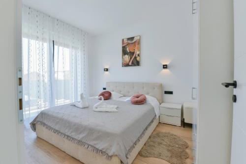 En eller flere senge i et værelse på Villa Gio