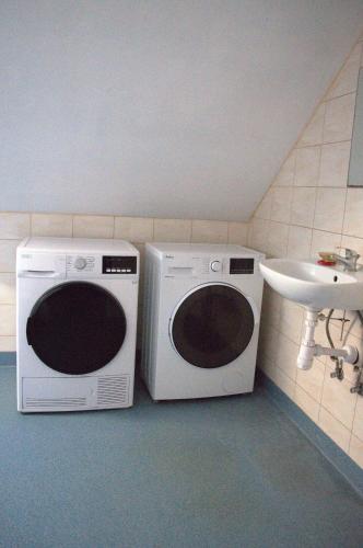 two microwaves sitting next to a sink in a bathroom at Lawendowa Przystań - Dolina Baryczy in Ujeździec Mały