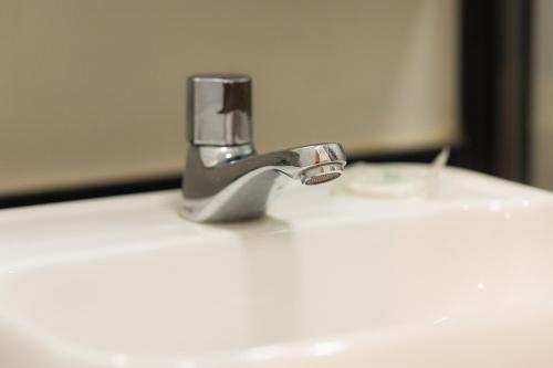 a bathroom sink with a faucet on top of it at SUH Copacabana 43 New Confort in Rio de Janeiro