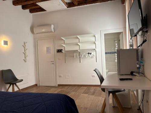 a bedroom with a bed and a desk and a table at Casa Giardini in Venice