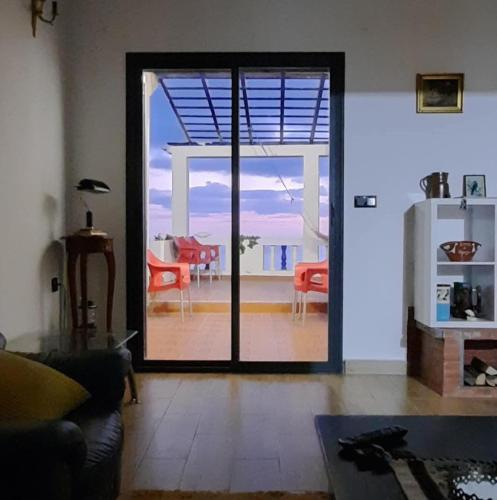 a living room with a sliding glass door to a patio at Blue ocean villa in Asilah
