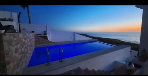 a swimming pool with a view of the ocean at Blue ocean villa in Asilah