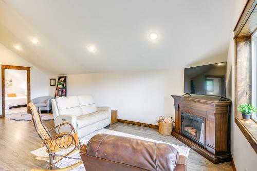 a living room with a couch and a fireplace at Mtn and River-View Gem with Balcony in Bonners Ferry in Bonners Ferry