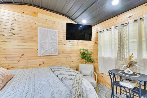 a bedroom with a bed and a tv on a wall at Hot Tub, Fire Pit Lake-View Catlettsburg Getaway! in Catlettsburg