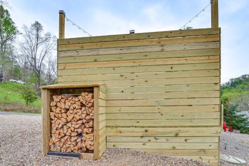 a wooden building with a pile of fire wood at Hot Tub, Fire Pit Lake-View Catlettsburg Getaway! in Catlettsburg