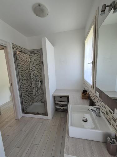 a white bathroom with a sink and a shower at A casa di Elena in Lesa