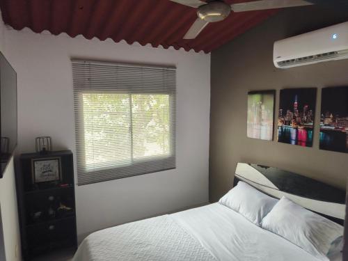 a bedroom with a bed and a window at Casa Terraza in El Zaino