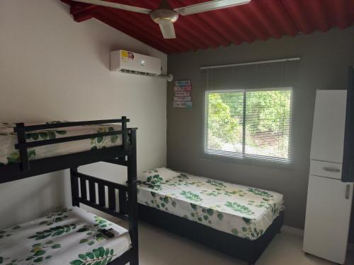 a bedroom with two bunk beds and a window at Casa Terraza in El Zaino