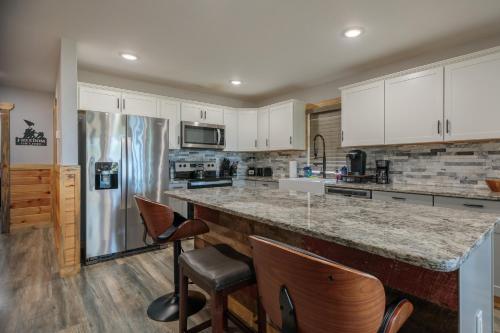 a kitchen with white cabinets and a large counter top at Hot Tub and Mini Golf Mtn-View Haven in Kodak! in Kodak