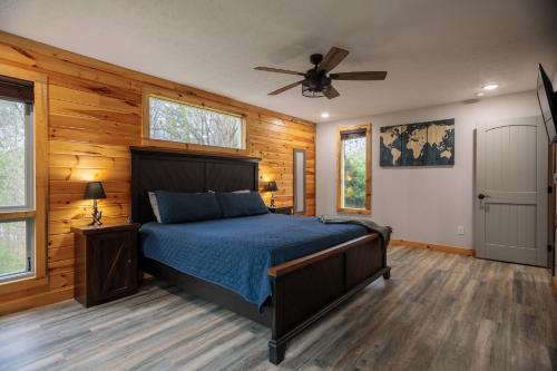 a bedroom with a bed and a ceiling fan at Hot Tub and Mini Golf Mtn-View Haven in Kodak! in Kodak