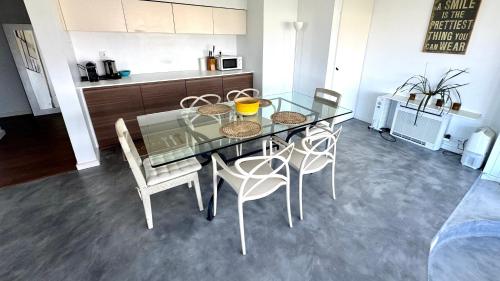 een eetkamer met een glazen tafel en stoelen bij one bedroom plus 1 extra room Nomad Dreams N6 in Cascais mountain view in Cascais