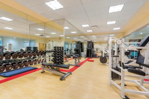 a gym with a lot of equipment in a room at Embarc Vancouver in Vancouver
