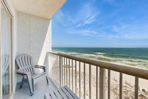 a balcony with a chair and a view of the ocean at Islander W 703 in Fort Walton Beach