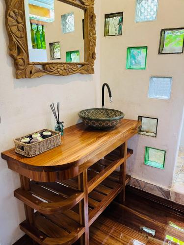 a bathroom counter with a sink and a mirror at Colibri Ecolodge 3 minutes walk to beach and town in Puerto Viejo
