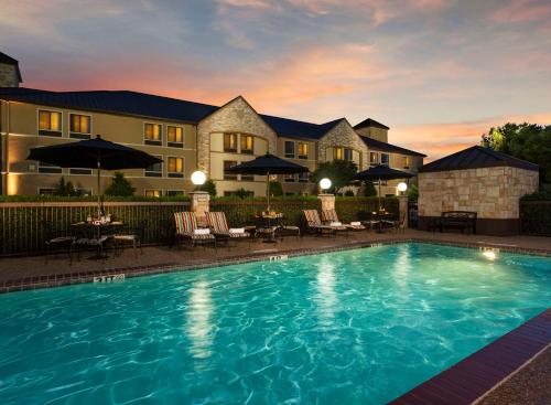 a swimming pool in front of a hotel at Best Western Plus Lewisville Flower Mound in Lewisville