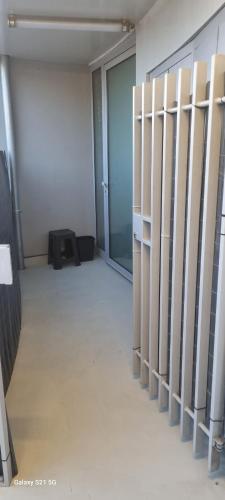 an empty room with a hallway with a glass door at Le Repos Urbain-Grand T3 Cosy à 10 min de Paris & CDG in La Courneuve