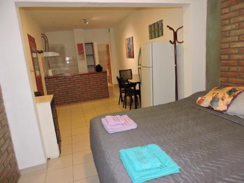 a bedroom with a bed with two towels on it at Departamentos Mercedes VM in Villa Mercedes