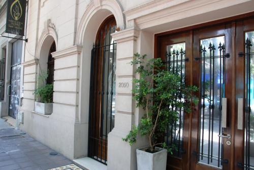 a building with a door and a potted plant at Miravida Soho Hotel & Wine Bar in Buenos Aires