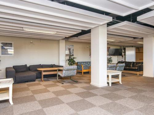 a lobby with couches and a table and chairs at Room in Hotel Fano for 4 guests in Fanø