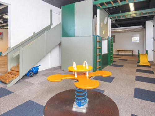 a childrens play room with a table and a staircase at 6 person holiday home on a holiday park in Fanø in Fanø