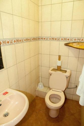 a bathroom with a toilet and a sink at Khweza Bed and Breakfast in Nairobi